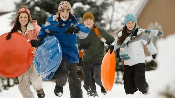 a group of children playing in the snow