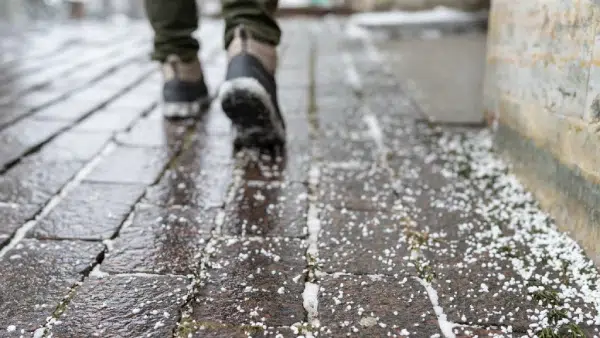 a man walking on an icy sidewalk